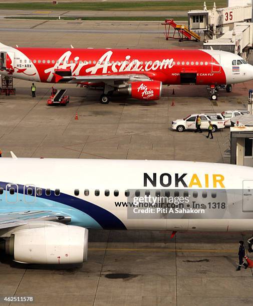 Nok Air air-plane parked near an AirAsia air-plane at the terminal building at the Don Mueang airport in Bangkok. A major low-cost airline in...