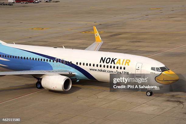 Nok Air air-plane parked at the terminal building at the Don Mueang airport in Bangkok. A major low-cost airline in Thailand, Nok Air is the budget...