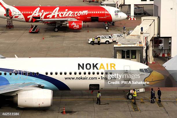 Nok Air air-plane parked near an AirAsia air-plane at the terminal building at the Don Mueang airport in Bangkok. A major low-cost airline in...