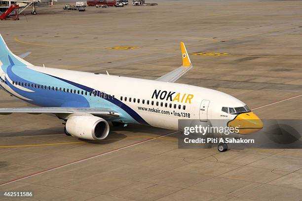 Nok Air air-plane parked at the terminal building at the Don Mueang airport in Bangkok. A major low-cost airline in Thailand, Nok Air is the budget...