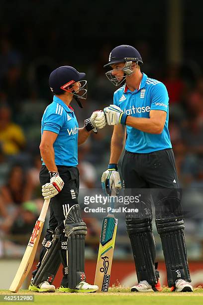 James Taylor and Jos Buttler of England touch gloves during the One Day International match between England and India at WACA on January 30, 2015 in...