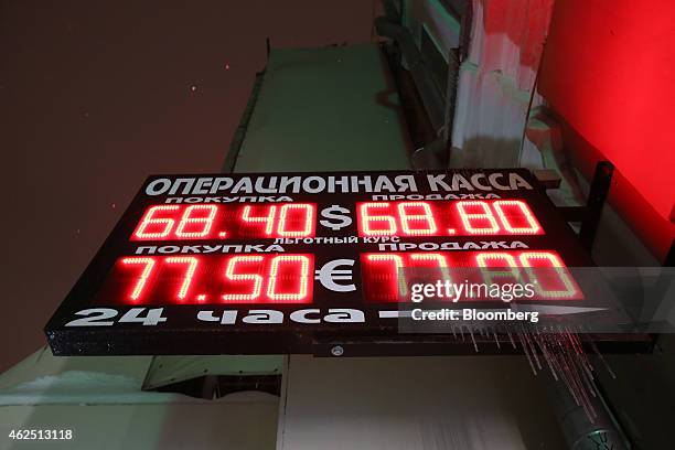 Icicles hang from an electronic sign advertising exchange rates for euros, dollars and rubles outside a currency exchange store in Moscow, Russia, on...