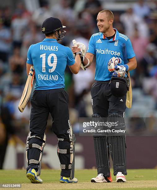 Chris Woakes and Stuart Broad of England celebrate after winning the One Day International match between England and India at WACA on January 30,...