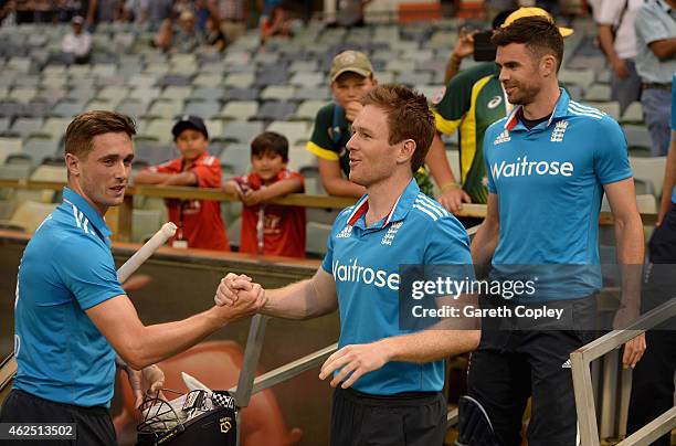 Chris Woakes of England shakes hands with captain Eoin Morgan after winning the One Day International match between England and India at WACA on...