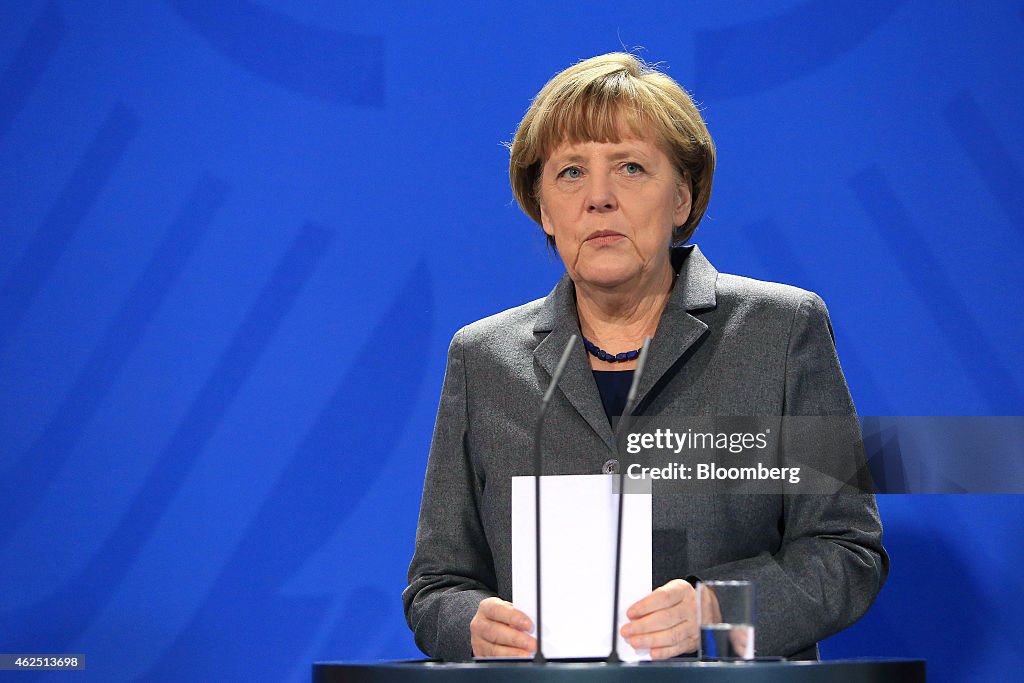 Germany's Chancellor Angela Merkel Unveils Two-Euro Reunification Coin