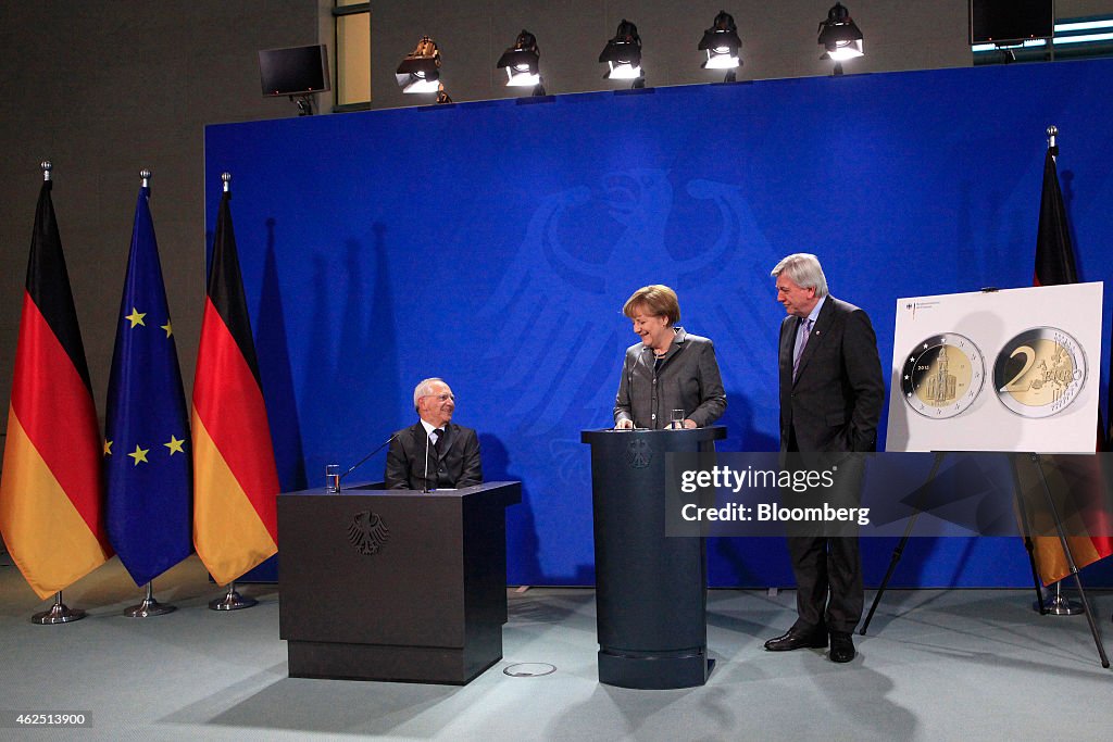 Germany's Chancellor Angela Merkel Unveils Two-Euro Reunification Coin