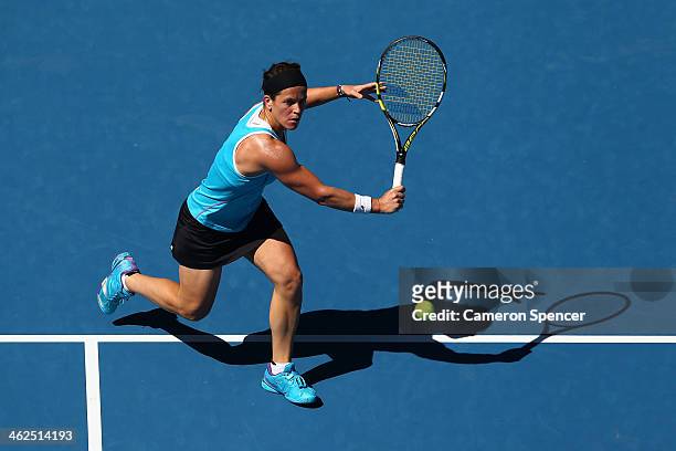 Lourdes Dominguez Lino of Spain plays a backhand in her first round match against Caroline Wozniacki of Denmark during day two of the 2014 Australian...