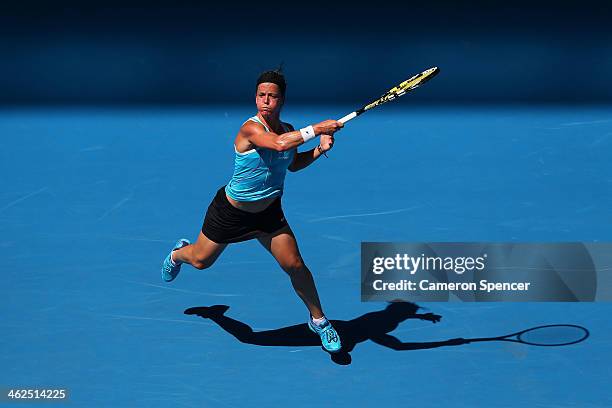 Lourdes Dominguez Lino of Spain plays a forehand in her first round match against Caroline Wozniacki of Denmark during day two of the 2014 Australian...