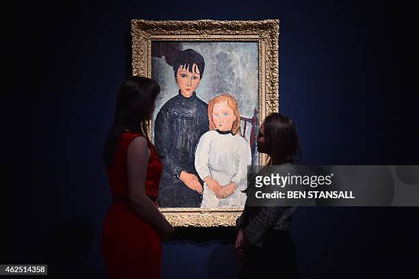Members of staff look at a work of art by Amedeo Modigliani entitled "Les deux filles," which is estimatd to fetch 6-8 million British pounds ,...