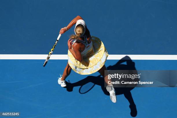 Caroline Wozniacki of Denmark plays a forehand in her first round match against Lourdes Dominguez Lino of Spain during day two of the 2014 Australian...