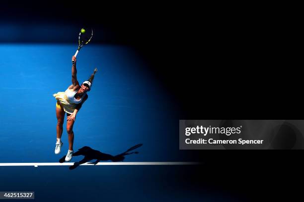 Caroline Wozniacki of Denmark serves in her first round match against Lourdes Dominguez Lino of Spain during day two of the 2014 Australian Open at...