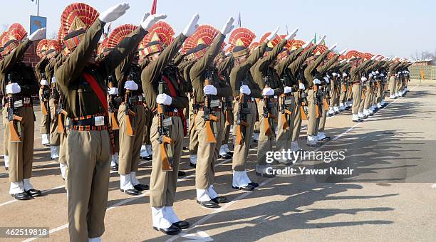 Indian Border Security Force soldiers raise their hands to take oath during their passing out parade on January 30, 2015 in Humhama, on the outskirts...