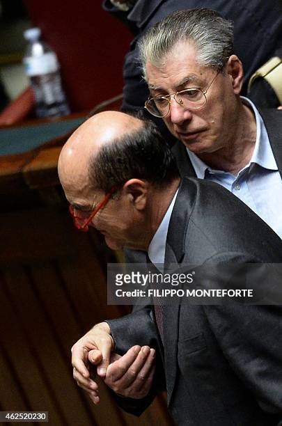 Former secretary of the Italian Democratic party Pierluigi Bersani greets former leader of Italy's Northern League party Umberto Bossi after casting...