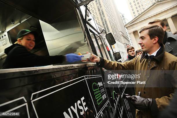 Free Shake Shack hamburgers are given out outside of the New York Stock Exchange during the burger company's IPO on January 30, 2015 in New York...