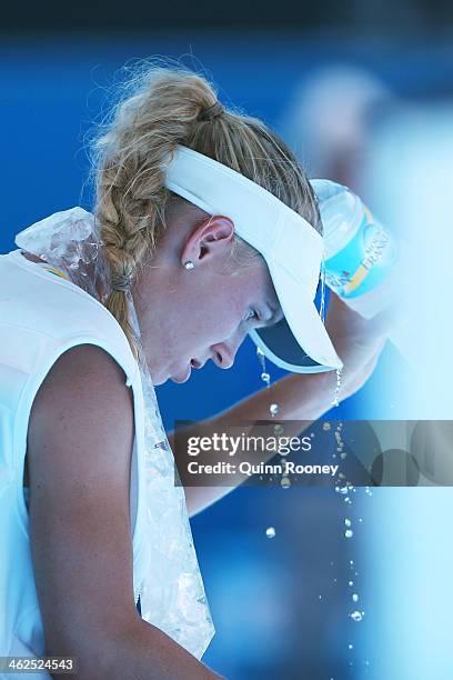 Caroline Wozniacki of Denmark cools off after winning her first round match against Lourdes Dominguez Lino of Spain during day two of the 2014...