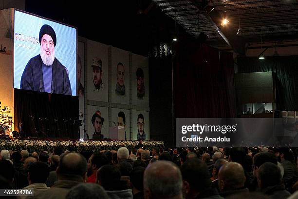 Hezbollah chief Hassan Nasrallah speaks via video conference during the commemoration ceremony for killed militants of Hezbollah in Syria, on January...