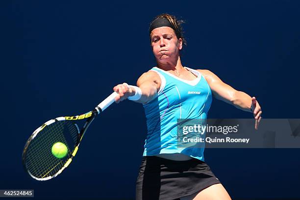 Lourdes Dominguez Lino of Spain plays a forehand in her first round match against Caroline Wozniacki of Denmark during day two of the 2014 Australian...