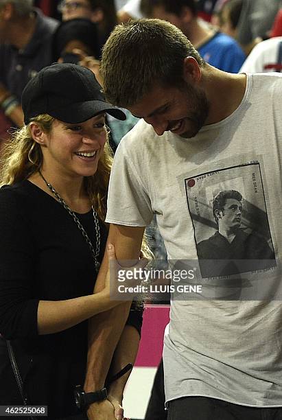 Barcelona's defender Gerard Pique and his wife Colombian singer Shakira attend the 2014 FIBA World basketball championships quarter-final match...