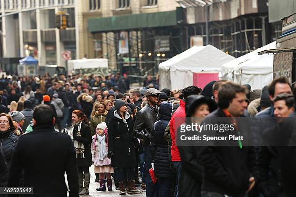 People line up for free Shake Shack hamburgers outside the New York Stock Exchange during the burger company's IPO on January 30, 2015 in New York...