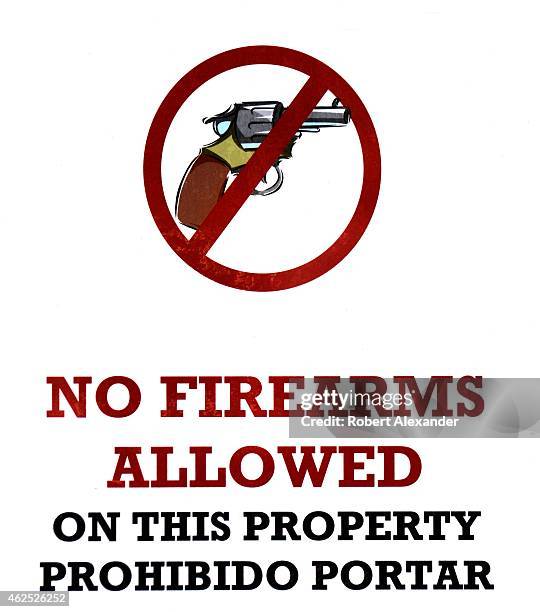 No Firearms Allowed' sign posted outside a business in Taos, New Mexico, declares that guns are not allowed inside.