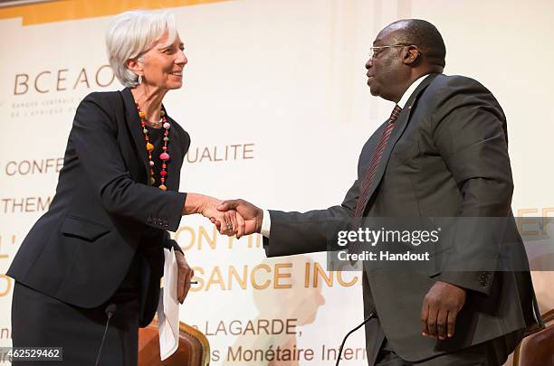 In this handout provided by the International Monetary Fund , International Monetary Fund Managing Director Christine Lagarde shakes hands shakes...