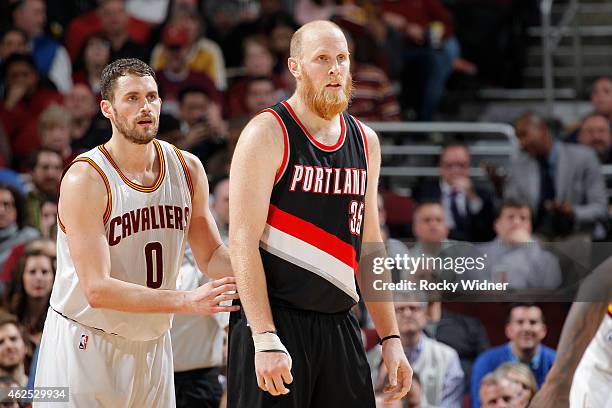 Chris Kaman of the Portland Trail Blazers faces off against Kevin Love of the Cleveland Cavaliers on January 28, 2015 at Quicken Loans Arena in...