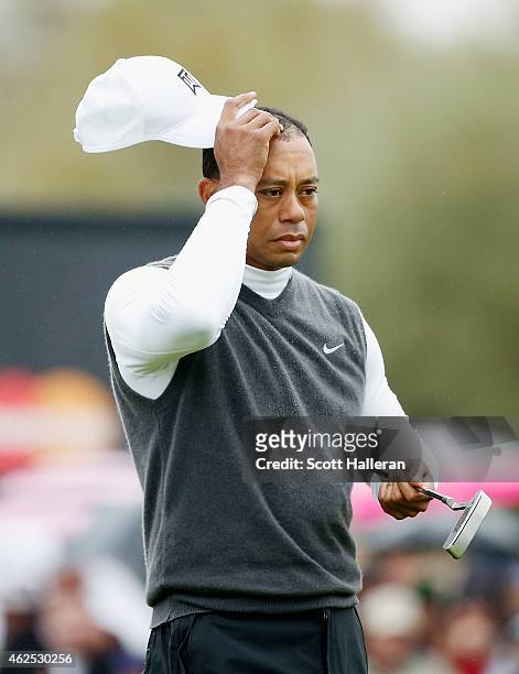 Tiger Woods waits on the ninth green after shooting an 11-over par 82 during the second round of the Waste Management Phoenix Open at TPC Scottsdale...