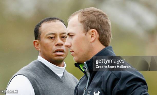 Tiger Woods greets Jordan Spieth on the ninth green after Woods shoot an 11-over par 82 during the second round of the Waste Management Phoenix Open...