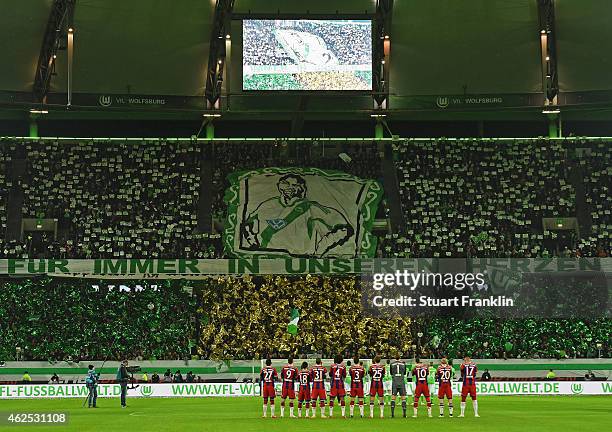 Fans and players remember former Wolfsburg player Junior Malanda, recently died in a car crash, prior to the Bundesliga match between VfL Wolfsburg...