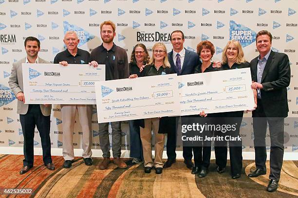 Quarterback Drew Brees and Dave Lindsey pose with Patrick Sells, Super Service Challenge Grand Prize Winners at the Super Service Challenge Press...