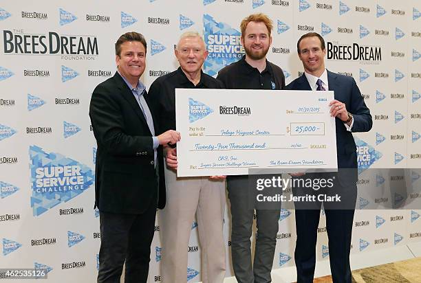 Quarterback Drew Brees and Dave Lindsey pose with CRF Inc Team at the Super Service Challenge Press Conference where Drew Brees Announces $1 000...
