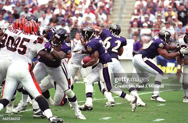 Running Back Priest Holmes of the Baltimore Ravens finds an openning to run a gain of a few extra yards during an NFL football game against the...