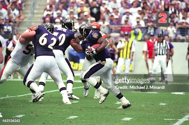 Running Back Priest Holmes of the Baltimore Ravens finds an openning to run a gain of a few extra yards during an NFL football game against the...