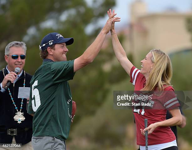 Bryce and Kelly Molder celebrate Kelly's tee shot at the PGA TOUR Wives Association charity golf outing during the Waste Management Phoenix Open, at...