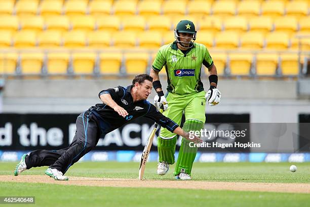 Nathan McCullum of New Zealand attempts to field off his own bowling Misbah-ul-Haq of Pakistan during the One Day International match between New...