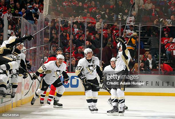 Simon Despres of the Pittsburgh Penguins celebrates with Sidney Crosby of the Pittsburgh Penguins and teammates after scoring the game winning goal...