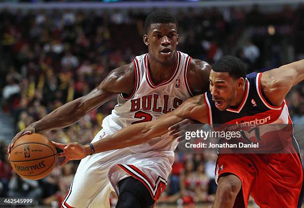 Garrett Temple of the Washington Wizards tries to knock the ball away from Jimmy Butler of the Chicago Bulls at the United Center on January 13, 2014...