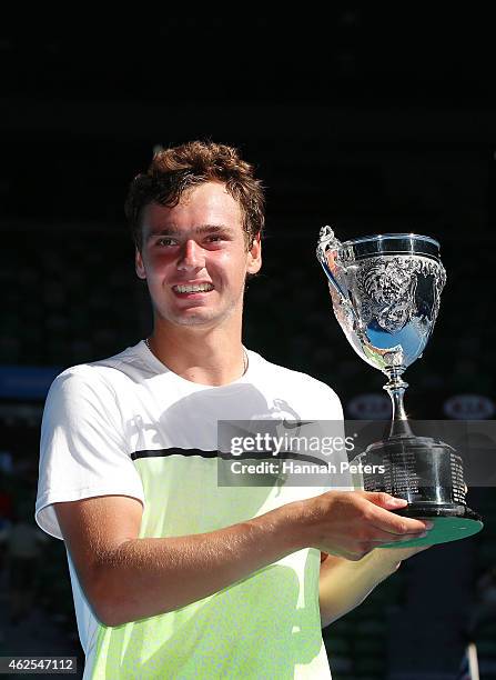 Roman Safiullin of Russia holds the winners trophy after winning the Junior Boys' Singles Final match against Seong-chan Hong of Korea during the...