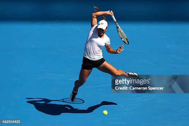 Yulia Putintseva of Kazakhstan plays a backhand in her first round match against Agnieszka Radwanska of Poland during day two of the 2014 Australian...