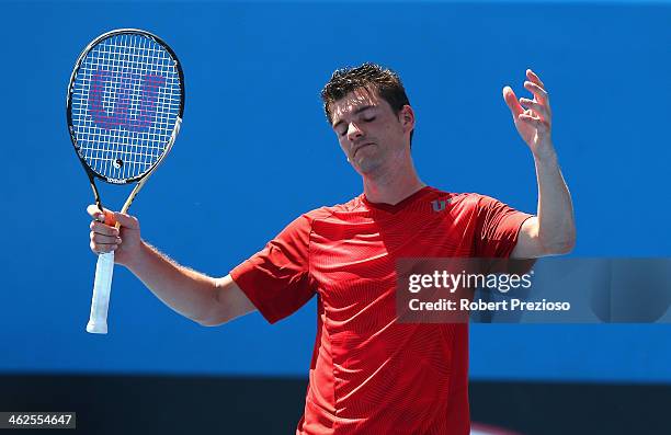 Frank Dancevic of Canada reacts in his first round match against Benoit Paire of France during day two of the 2014 Australian Open at Melbourne Park...