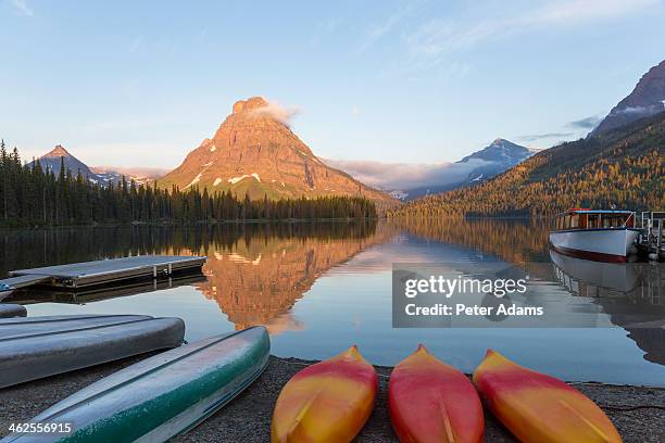 canoes at two medicine lake - two medicine lake montana stock pictures, royalty-free photos & images