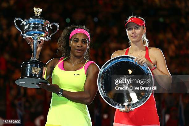 Serena Williams of the United States holds the Daphne Akhurst Memorial Cup and Maria Sharapova of Russia holds the runner up plate afte their women's...