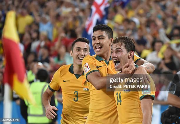 Australia's James Troisi celebrates scoring with teammates Jason Davidson and Massimo Luongo during the AFC Asian Cup football final between South...
