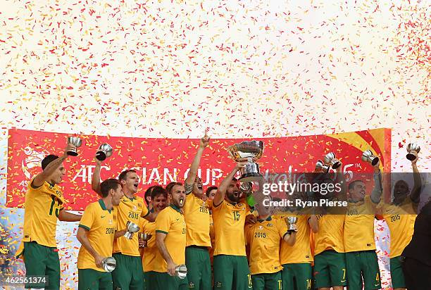 Australia celebrate with the trophy during the 2015 Asian Cup final match between Korea Republic and the Australian Socceroos at ANZ Stadium on...