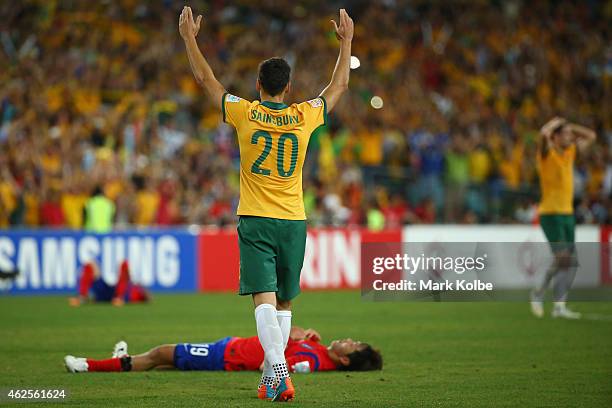 Trent Sainsbury of Australia celebrates victory as Kim Young Gwon of Korea Republic lies dejected on the ground during the 2015 Asian Cup final match...