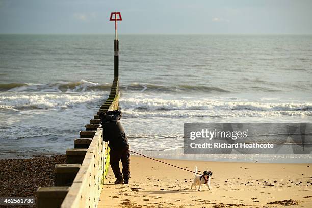 Dog walker takes a picture of the sea crashing into a groyne at Boscombe beach before the Sky Bet Championship match between AFC Bournemouth and...