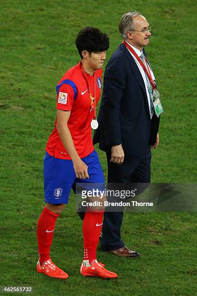 Korea Republic coach, Ulrich Stielike and Son Heung Min of Korea Republic walk from the field following the 2015 Asian Cup final match between Korea...