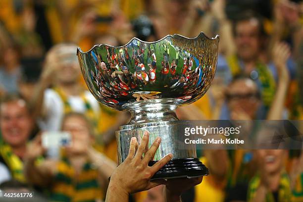 Tim Cahill of Australia carries the trophy aloft on the lap of honour during the 2015 Asian Cup final match between Korea Republic and the Australian...
