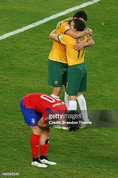 Mile Jedinak of Australia celebrates with team mate Matt McKay at full time after victory over Korea Republic following the 2015 Asian Cup final...
