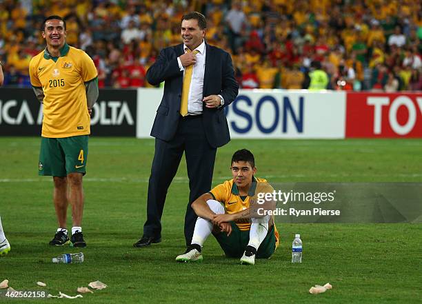 Australian coach Ange Postecoglou, Tim Cahill of Australia and Massimo Luongo of Australia look on after the 2015 Asian Cup final match between Korea...